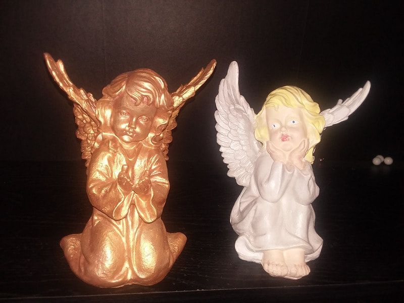 two resin angels painted one gold one regular to show samples of variety 